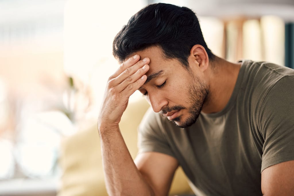 Man showing signs of anxiety and mental fatigue